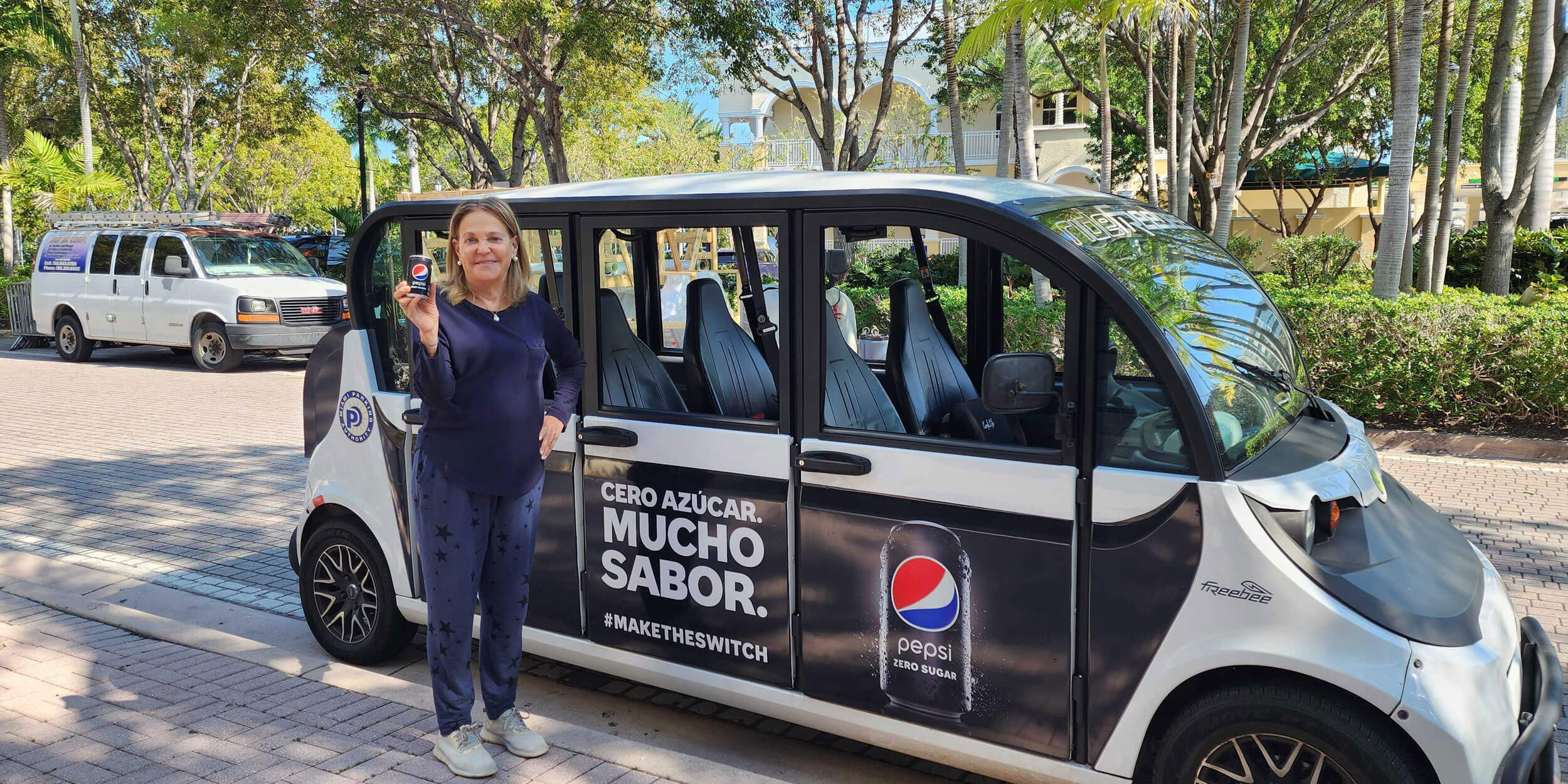 Woman holding a Pepsi and a Freebee car plotted for a Pepsi campaign